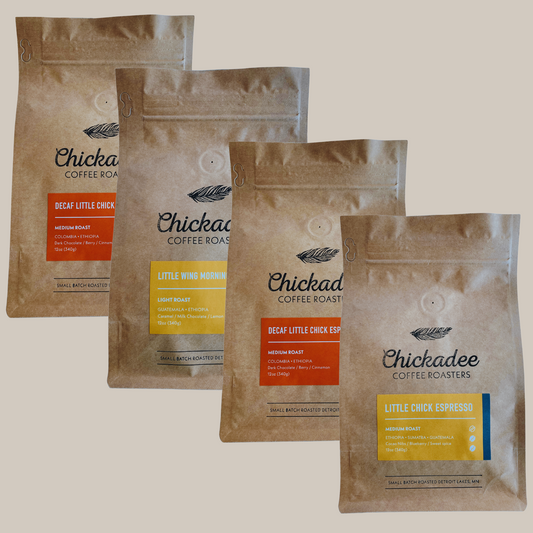 The Chickadee Coffee Roasters Variety Bundle (4 Pack) features four bags, each with a vibrant label: Decaf Little Chick Espresso, Little Wing Morning, Decaf Little Chick Morning, and Little Chick Espresso.