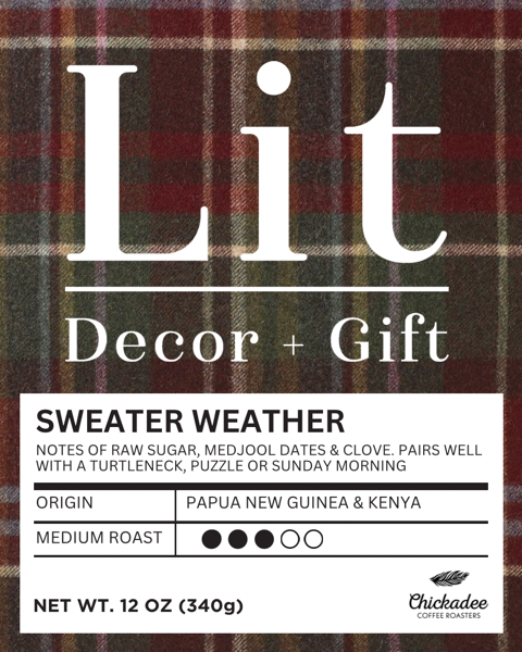 A 12 oz Lit Sweater Weather Blend coffee bag by Chickadee Coffee Roasters, with a plaid label. Medium roast from Papua New Guinea & Kenya; bold flavor with tasting notes of sugar, dates, and clove.